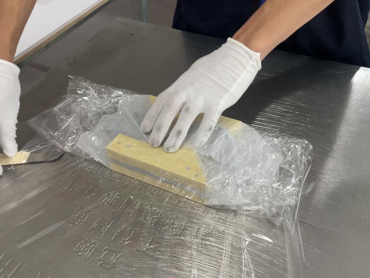 Wrapping gold letter in bubble wrap