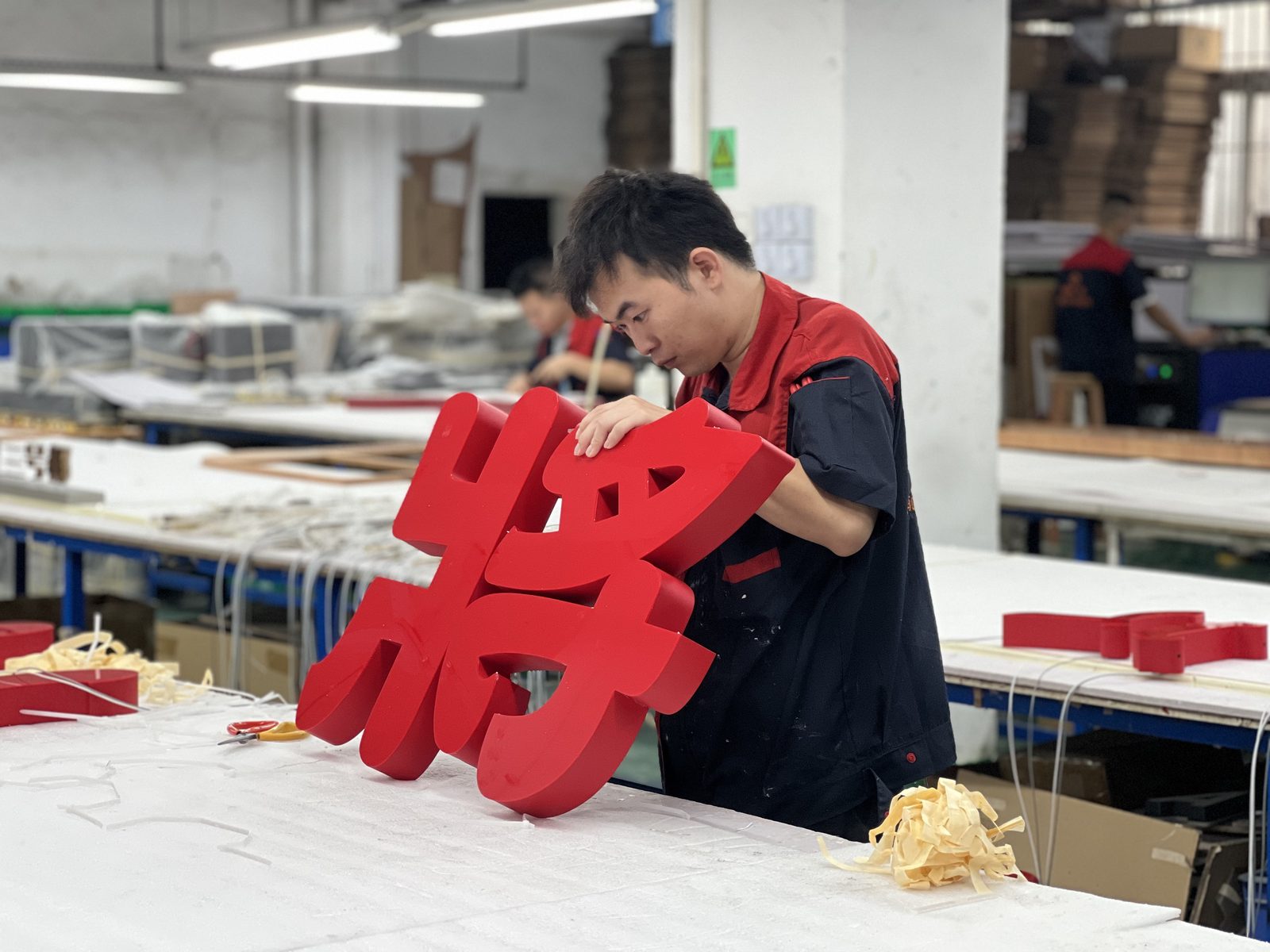 Large red fabricated channel letters in production