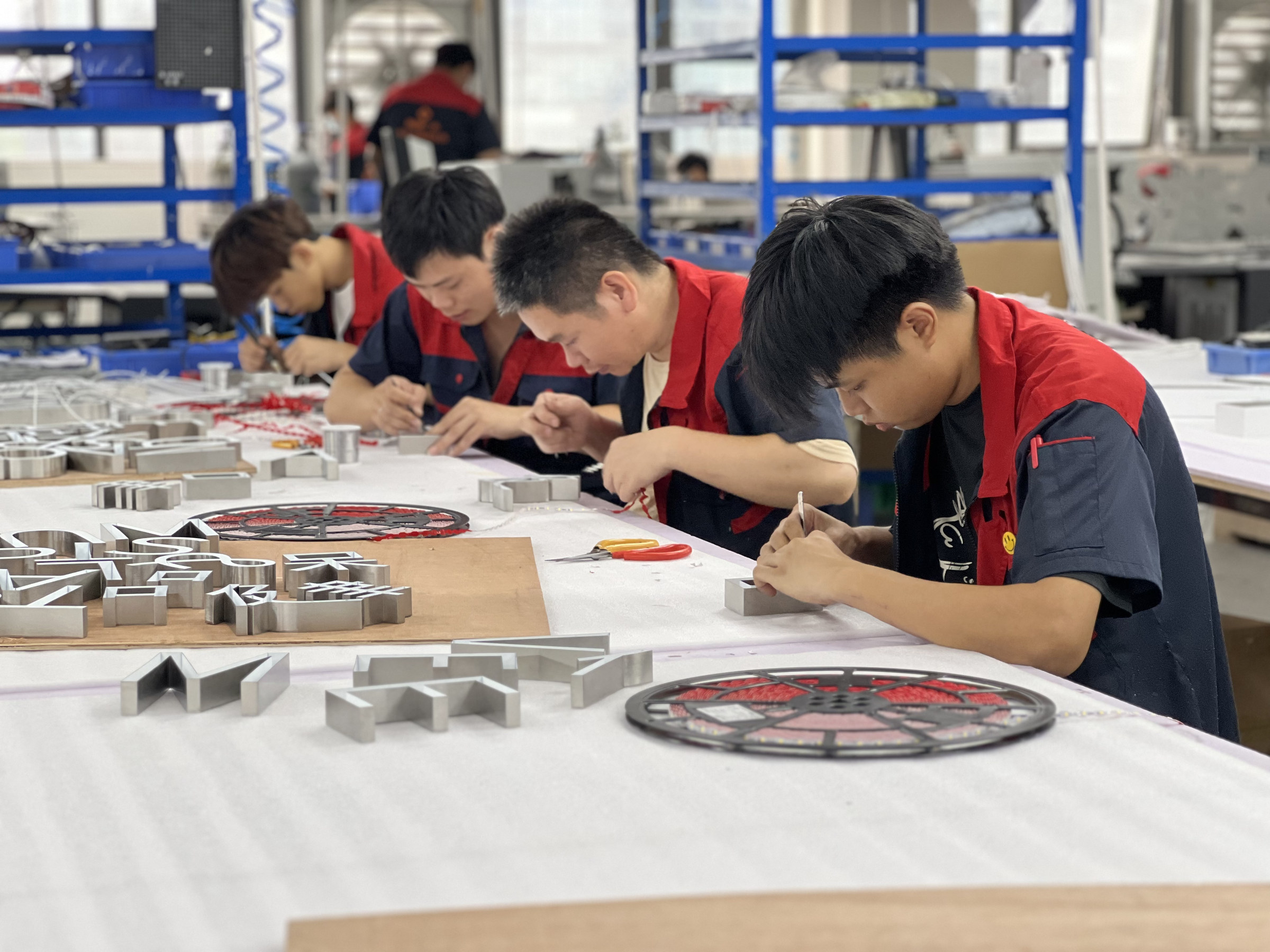 Assembling custom lettering at the HeFeng factory